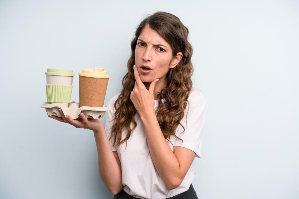 Can I drink Starbucks and still lose weight: Person enjoying a healthy snack and coffee at a Starbucks table, focusing on mindful eating in a cozy cafe setting.