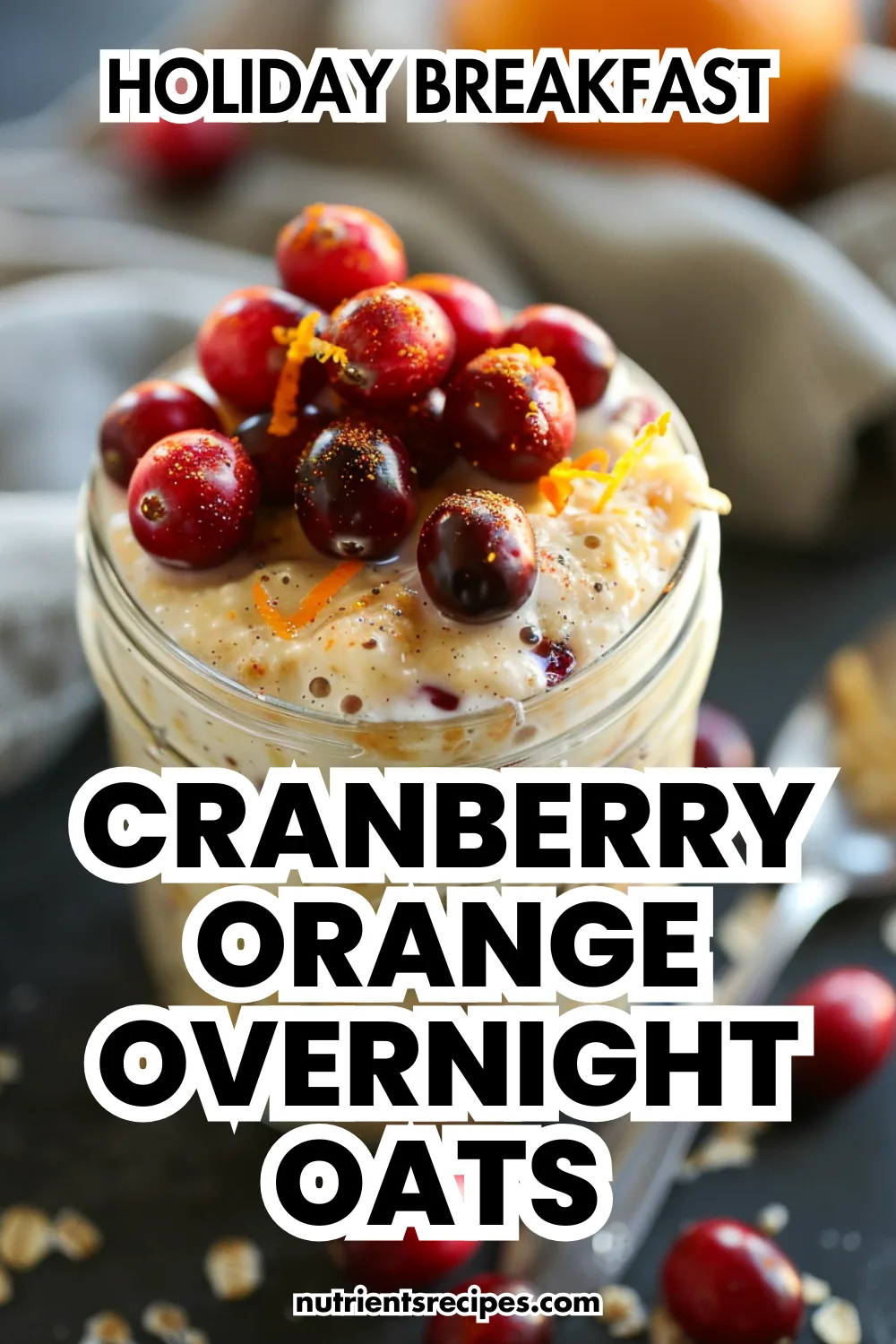 Cranberry orange overnight oats in a glass jar, topped with fresh berries and zest