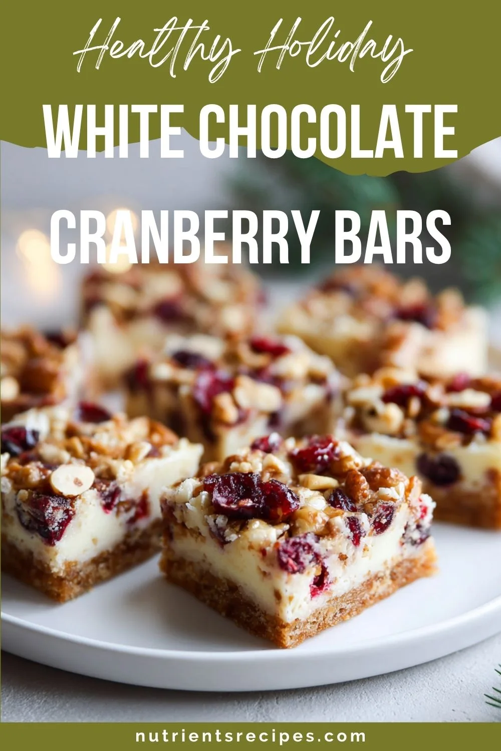 NUTRIENTS Recipes White Chocolate Cranberry Bars White chocolate cranberry oat bars cut into squares on parchment paper in bright natural kitchen light.